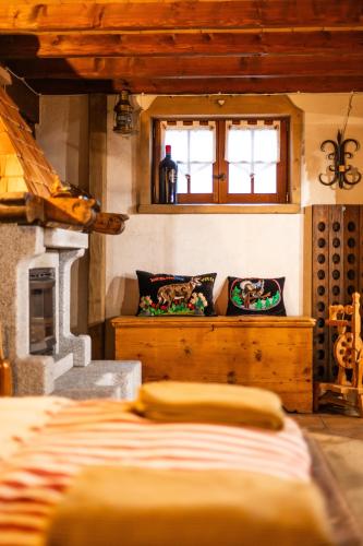 a bedroom with a fireplace and a bed in a room at Alfio's Alpen Suite in Roncone