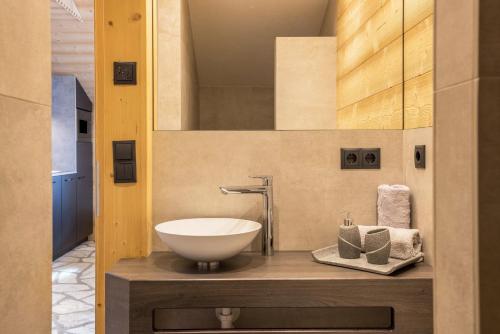a bathroom with a bowl sink on a counter at Chalets Reisnock - Hochgruberhof in Selva dei Molini
