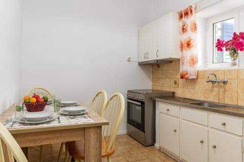 a kitchen with a table with a bowl of fruit on it at Margaret House in Parikia