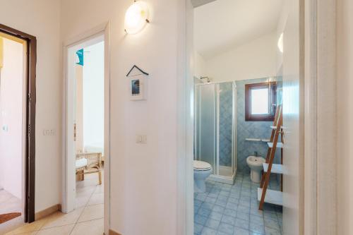 a bathroom with a toilet and a walk in shower at Casa Vacanze Pistacchio in Murta Maria
