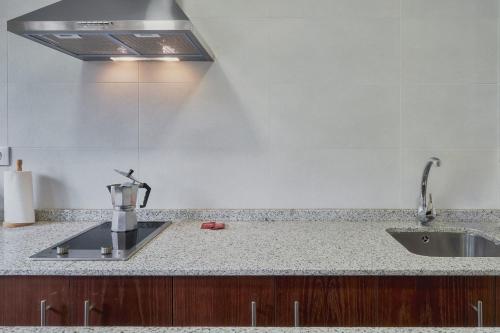 a kitchen with a sink and a counter top at Valle del Ibias - Primero Derecha in Cecos