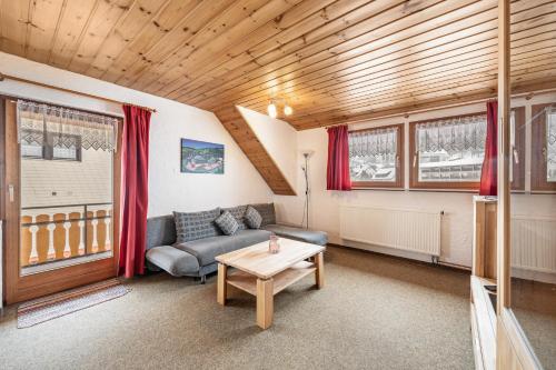 a living room with a couch and a table at Haus Schöneck in Todtnauberg