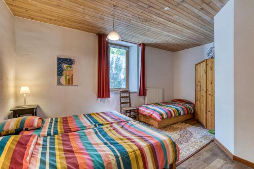 a bedroom with two beds and a window at Maison Abricot avec piscine in Aspiran