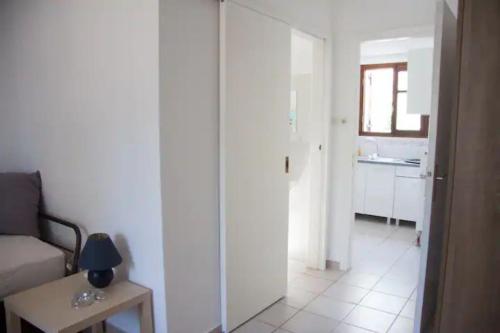 a white living room with a couch and a table at Maria's house 2 in Ilia