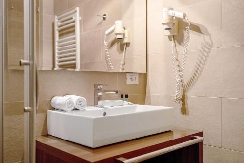 a bathroom with a white sink and a mirror at Kriendl Nr 2 in Valdaora