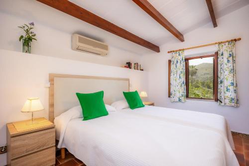 a bedroom with a white bed and a window at La Fortaleza in Pollença