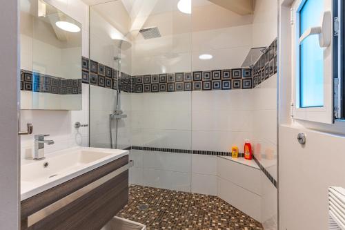 a bathroom with a tub and a sink and a shower at Maison Le Moulleau in Arcachon