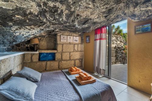 a bedroom with a bed in a cave at Finca Toledo in San Miguel de Abona