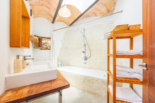 a bathroom with a sink and a tub and a shower at Els Abats in Fornalutx
