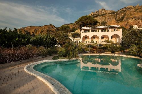a large swimming pool in front of a building at Tenuta Del Poggio Antico in Ischia