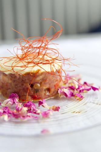 a piece of food on a plate with purple flowers at Villa Bucher - Metnitztalerhof in Friesach