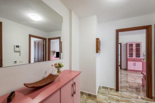 a bathroom with a pink vanity and mirrors at Lujan 6f Entre Sueños Y Realidad in Puntallana
