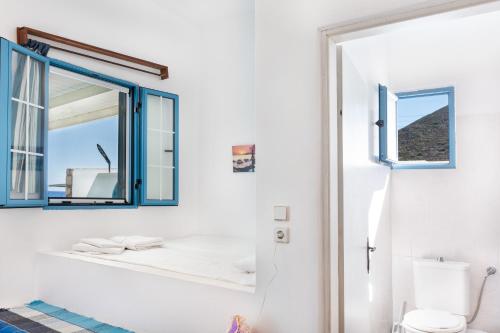 a bathroom with a mirror and a toilet at Beachfront Lampis Dolphin 2 in Skala