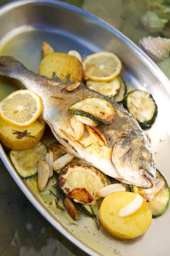 a plate of food with a fish and vegetables at Villa Bucher - Metnitztalerhof in Friesach