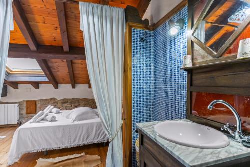 a bathroom with a bed and a sink in a room at La Breval in Alles