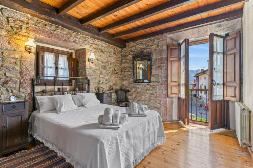 a bedroom with a large bed in a stone wall at La Breval in Alles