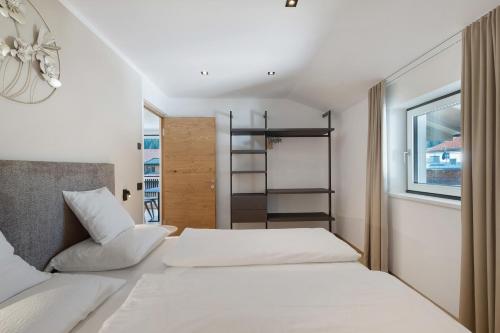 a bedroom with two beds and a window at Premium App Hofer Marianna in Villabassa