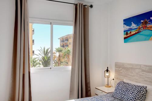 a bedroom with a window with a view of a city at Casa Roberto in Candelaria