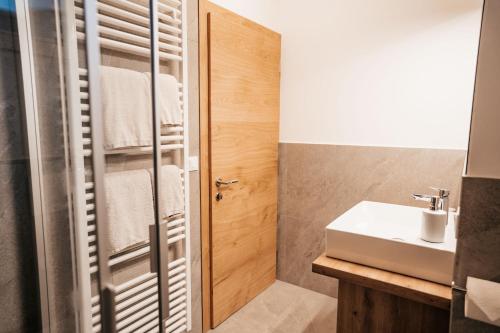 a bathroom with a sink and a shower at Apartment Ida - Obermösslhof in Lana