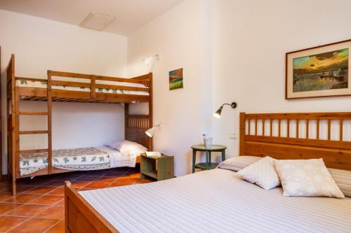 two beds in a room with two bunk beds at Bilo Camelia in Marina di Grosseto