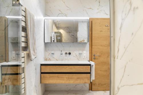 a bathroom with a sink and a mirror at Ferienwohnung Elsa in Fliess