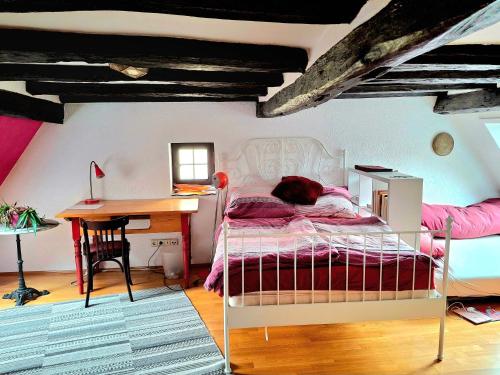 a bedroom with a bed and a desk and a desk at Charming House in Neckargemünd