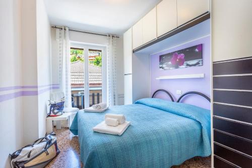 a blue bedroom with a blue bed and a window at Liver 203 in Tremosine Sul Garda