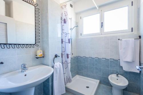 a bathroom with a sink and a toilet and a mirror at Liver 203 in Tremosine Sul Garda