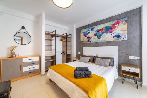 a bedroom with a bed and a painting on the wall at Laguna beach Vera in Vera