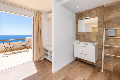 a bathroom with a view of the ocean at Villa Domus Alba A - B in Felanitx