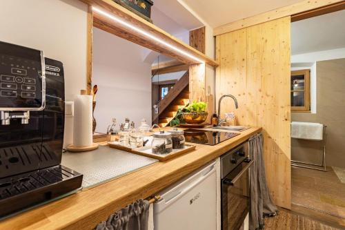 a kitchen with a sink and a microwave at Ferienappartement 1 - Lockstein in Berchtesgaden