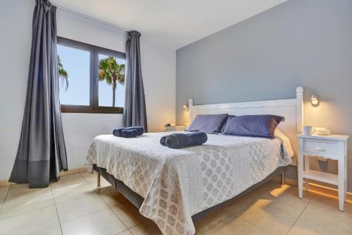 a bedroom with a bed with two pillows on it at Oasis Royal F306 in Corralejo