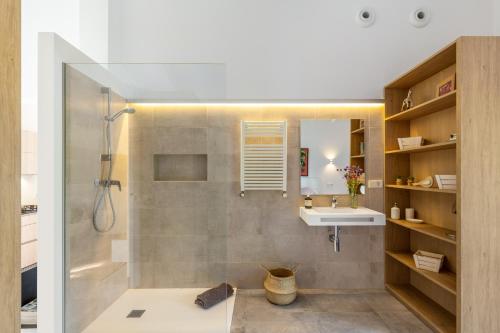 a bathroom with a shower and a sink at Sa Verdal in El Port de la Selva