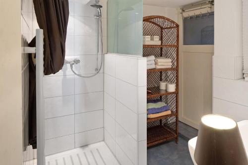 a bathroom with a shower with white tiles at Ferienwohnung Gill in Staufen im Breisgau