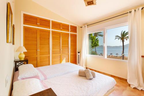 a bedroom with a large window with a view of the ocean at La Gola in La Manga del Mar Menor