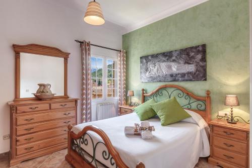 a bedroom with a bed and a dresser at Casa Paqui in Port de Soller