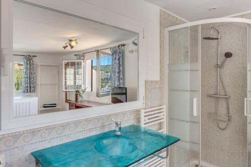 a bathroom with a blue sink and a mirror at Casa Paqui in Port de Soller