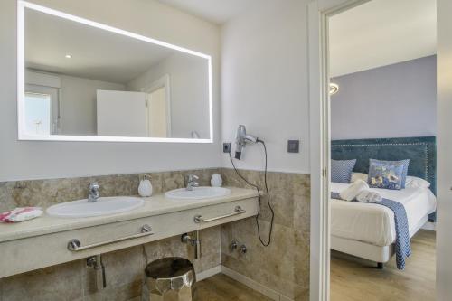 a bathroom with two sinks and a mirror at Luxury Tarifa in Tarifa