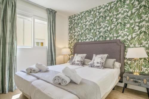 a bedroom with a bed with towels on it at Luxury Tarifa in Tarifa