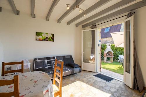 a living room with a couch and a sliding glass door at Gite La Salamandre in Saint-André-dʼAllas