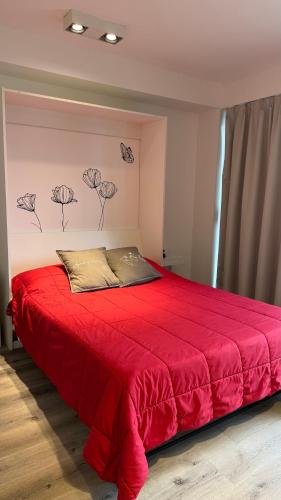 a bedroom with a red bed with a red blanket at 01 Tigre Stays in Tigre