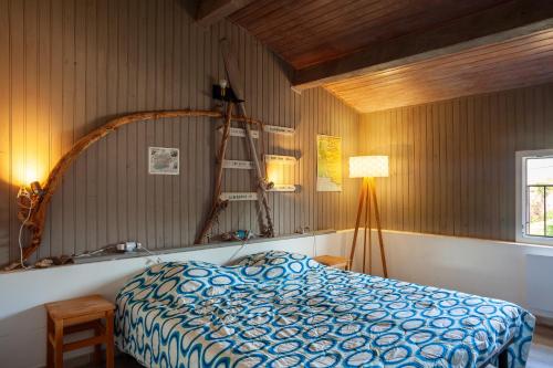 a bedroom with a bed and a mirror and a lamp at Maison Roxane in Six-Fours-les-Plages