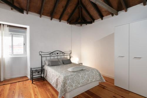 a bedroom with a bed and a wooden floor at Casa Rural tacoronte in Tacoronte