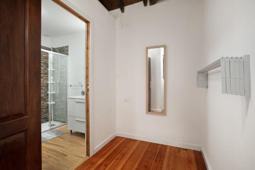 a hallway with white walls and a mirror on a wall at Casa Rural tacoronte in Tacoronte