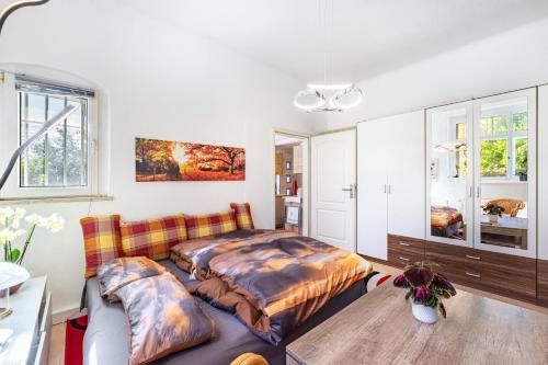 a bedroom with a bed and a couch at Fewo mit Terrasse Moritzburg in Moritzburg
