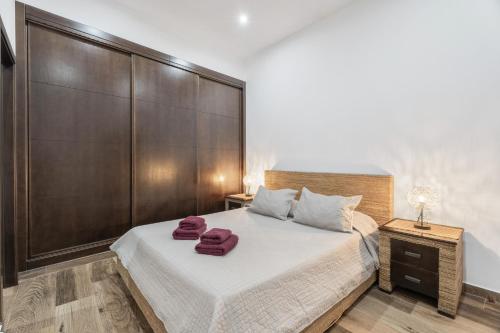 a bedroom with a large bed with two towels on it at Casa Rural Tijoco in Adeje