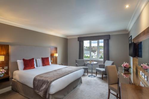 a hotel room with a bed and a desk at Canal Court in Newry