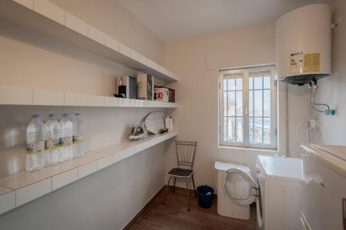 a bathroom with a sink and a toilet and a window at Casa Tilde in Matapozuelos