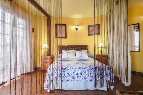 a bedroom with a bed with a blue and white blanket at Casa Carmela in La Guancha