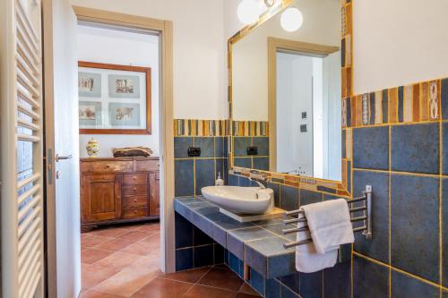 a bathroom with a sink and a mirror at Villa Glicine - Colleberto in Follonica